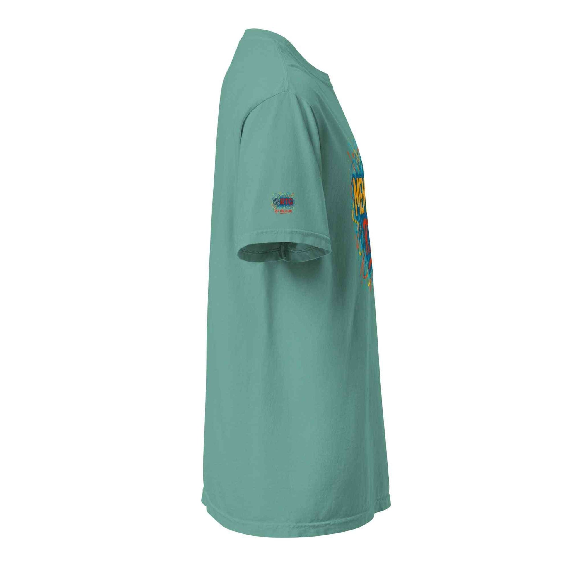 Side view of a unisex garment-dyed heavyweight t-shirt in teal color with short sleeves and relaxed fit